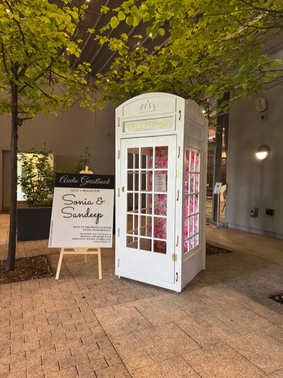 White telephone box audio guest book